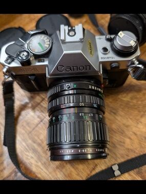 Canon Silver and Black AE-1 Film SLR Camera with Black Lens Barrel